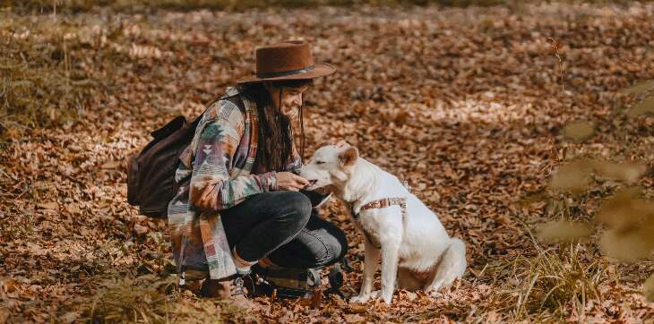 Woman feeding dog a treat