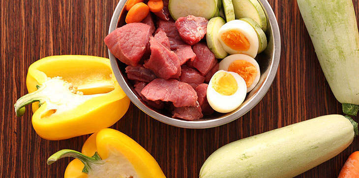 fresh food bowl, zucchini, carrot stick, yellow pepper, cutting board